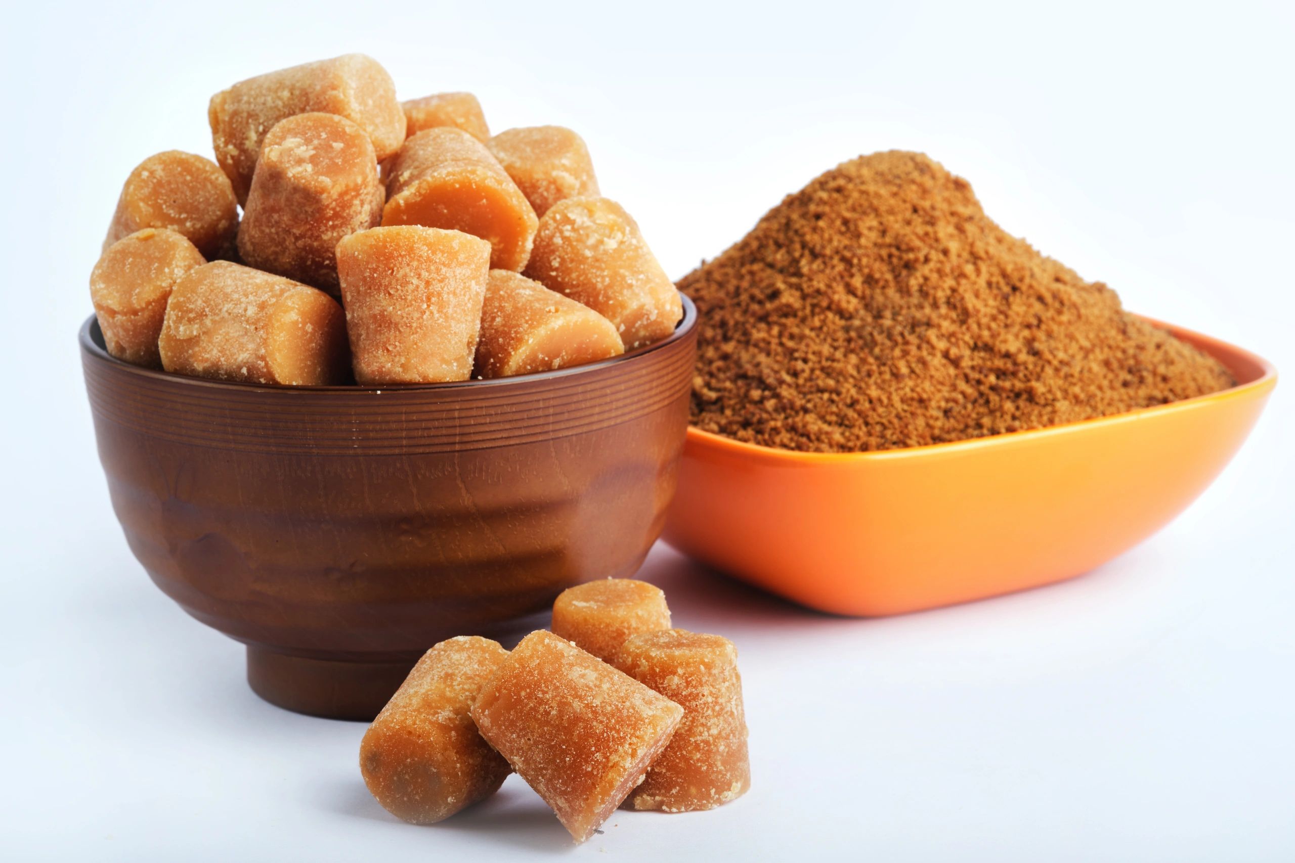 Jaggery powder and cubes in a rustic bowl