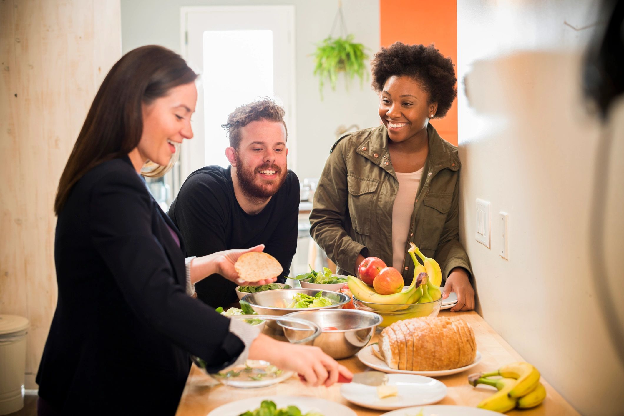 Team members preparing fresh ingredients together in a bright kitchen